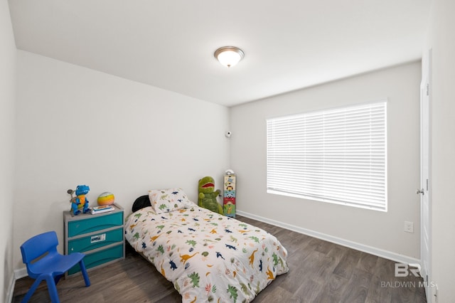 bedroom with dark wood-type flooring