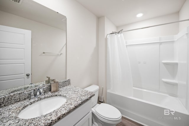 full bathroom with hardwood / wood-style floors, vanity, toilet, and shower / bathtub combination with curtain