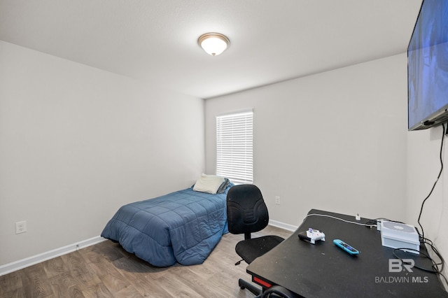 bedroom with hardwood / wood-style flooring