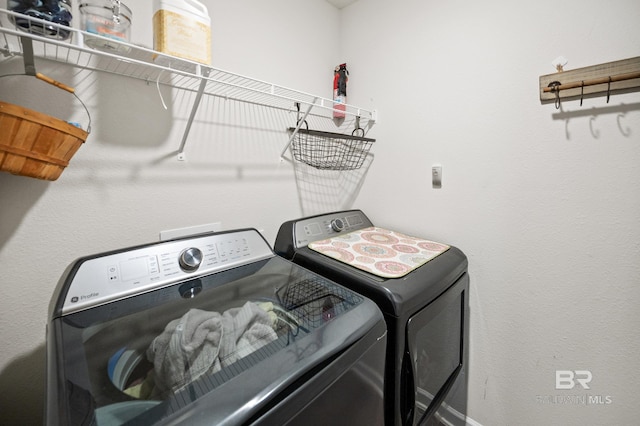 clothes washing area featuring washing machine and clothes dryer