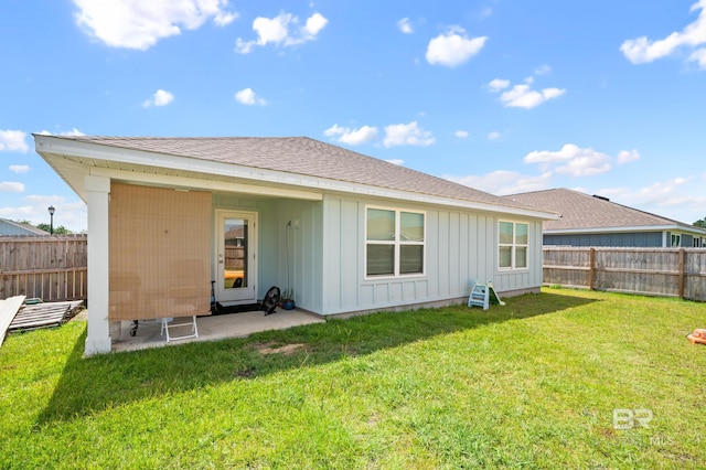 rear view of house with a yard