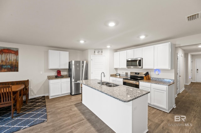 kitchen with a kitchen island with sink, white cabinetry, sink, and appliances with stainless steel finishes