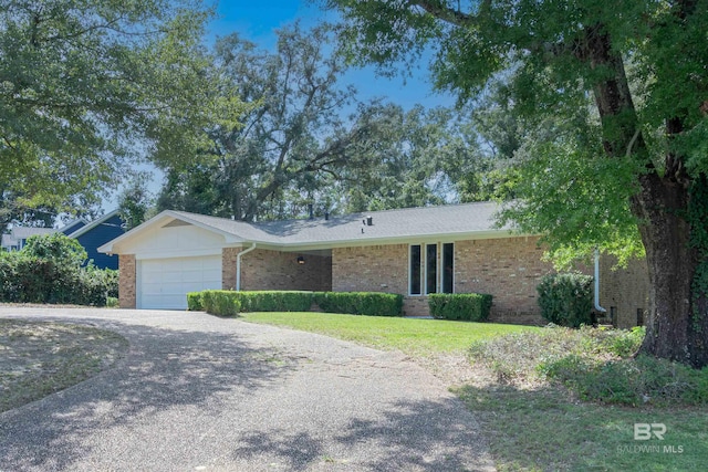 single story home featuring a front yard and a garage