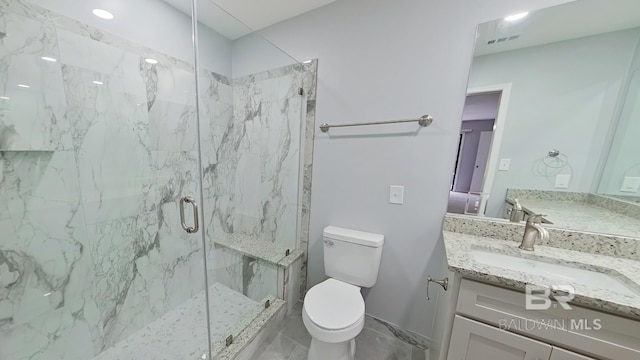 bathroom with vanity, toilet, and an enclosed shower