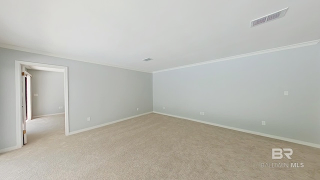 unfurnished room featuring ornamental molding and light colored carpet