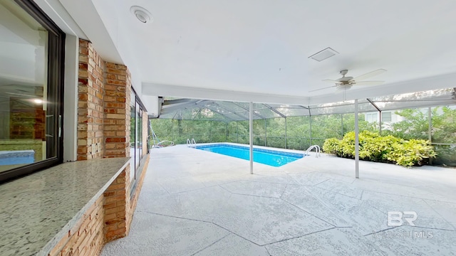 view of pool with a patio, ceiling fan, and a lanai