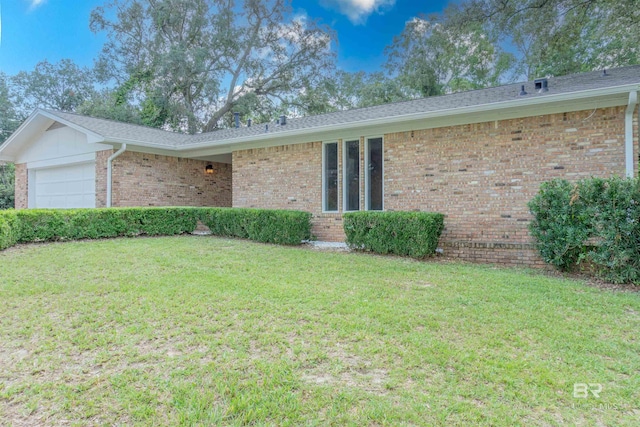 ranch-style home with a front yard and a garage