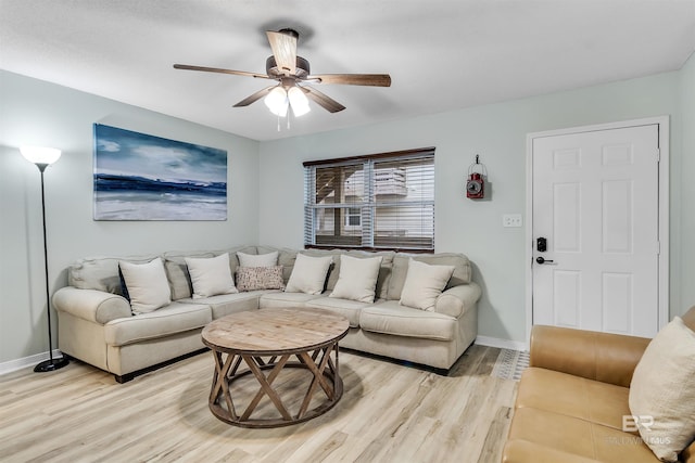 living room featuring ceiling fan and light hardwood / wood-style floors