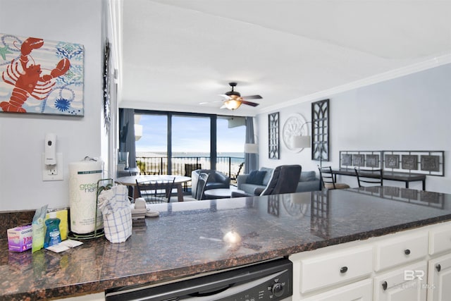 kitchen with ornamental molding, open floor plan, white cabinetry, dishwashing machine, and ceiling fan