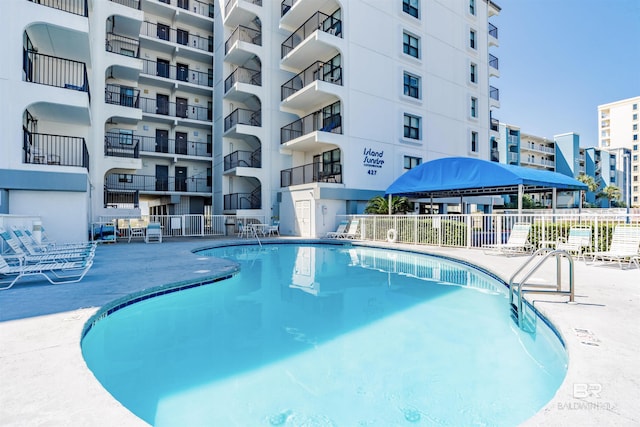 view of swimming pool with fence