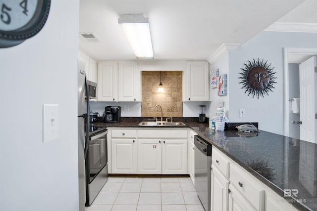 kitchen with visible vents, a sink, white cabinetry, stainless steel appliances, and light tile patterned floors