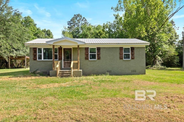 single story home featuring brick siding, crawl space, metal roof, and a front yard