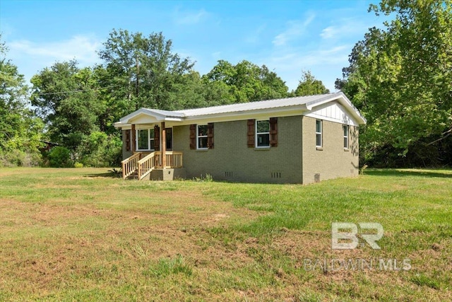 ranch-style home featuring a front lawn, brick siding, and crawl space