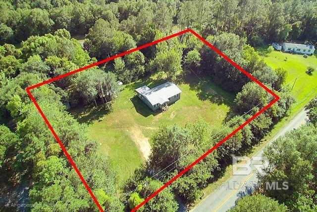 drone / aerial view with a wooded view