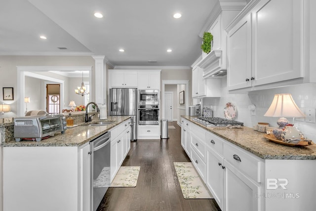 kitchen featuring appliances with stainless steel finishes, a sink, recessed lighting, white cabinetry, and a toaster