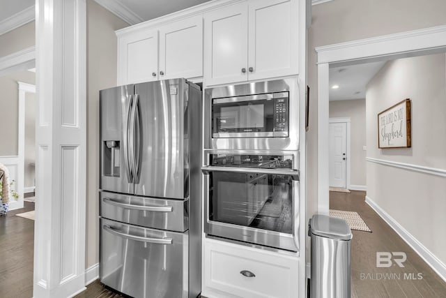 kitchen featuring dark wood finished floors, baseboards, white cabinets, stainless steel appliances, and recessed lighting