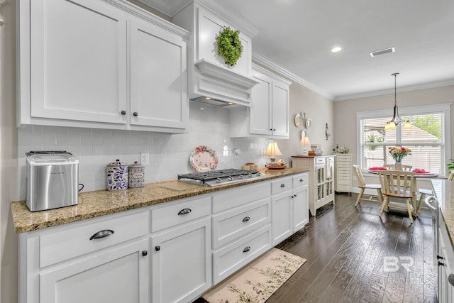 kitchen featuring visible vents, ornamental molding, white cabinetry, tasteful backsplash, and dark wood finished floors