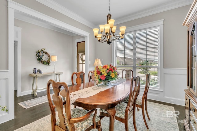 dining space with crown molding, dark wood-style flooring, and a chandelier