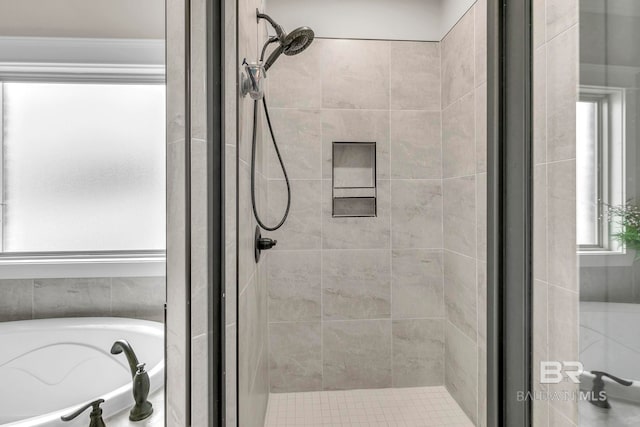 full bath featuring a garden tub, crown molding, and a shower stall