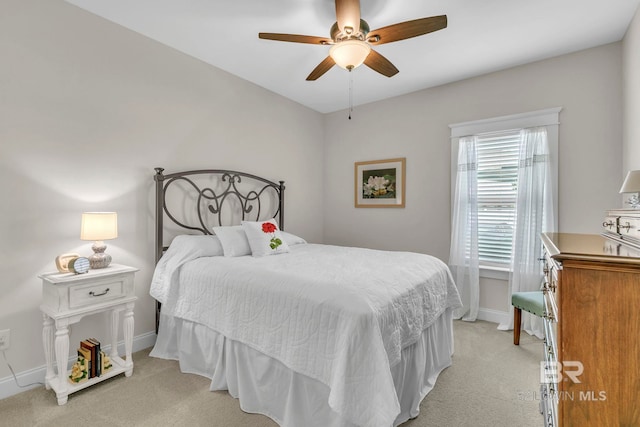 bedroom featuring a ceiling fan, baseboards, and light colored carpet