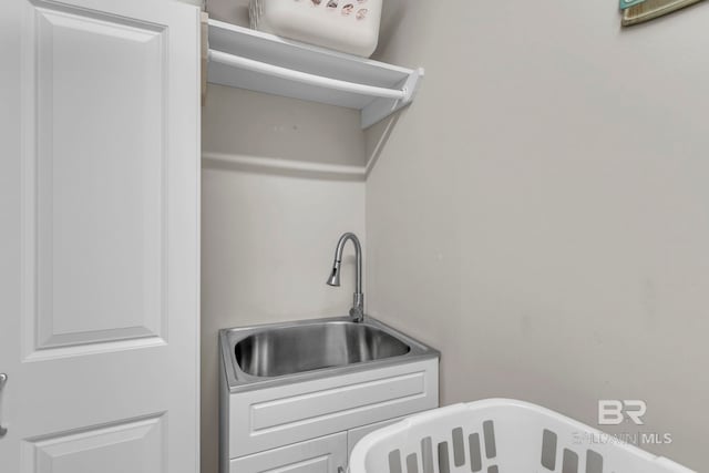 clothes washing area featuring a sink