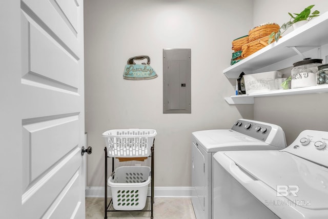 clothes washing area featuring baseboards, electric panel, independent washer and dryer, and laundry area