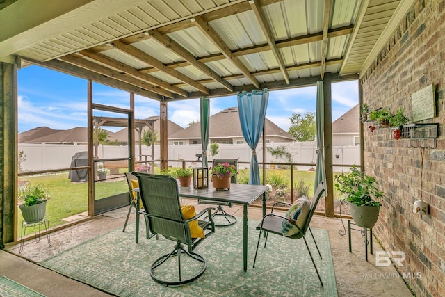 sunroom / solarium featuring a residential view