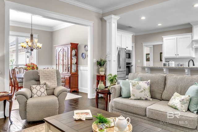 living area featuring ornamental molding, wainscoting, dark wood-style floors, recessed lighting, and a chandelier