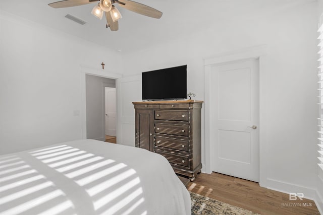 bedroom with ceiling fan and light hardwood / wood-style flooring