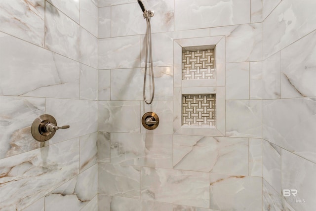 bathroom with tiled shower