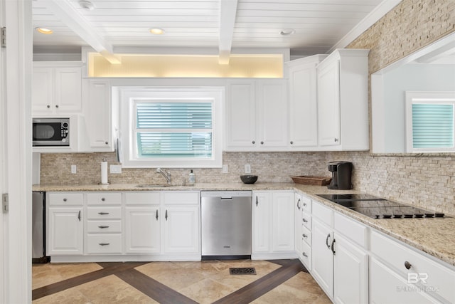1219 Parasol Pl, Perdido Key, FL 32507 - kitchen with appliances with stainless steel finishes, a sink, white cabinetry, decorative backsplash, and inlaid floor details