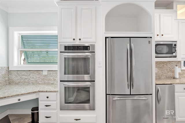 1219 Parasol Pl, Perdido Key, FL 32507 - kitchen with stainless steel appliances, tasteful backsplash, white cabinetry, and light stone countertops