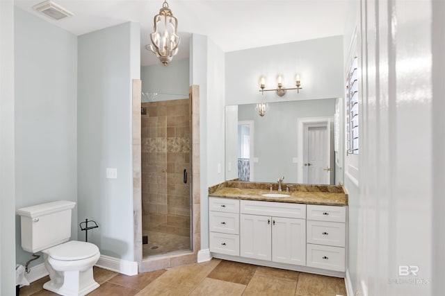 1219 Parasol Pl, Perdido Key, FL 32507 - bathroom featuring a shower stall, a chandelier, toilet, vanity, and tile patterned flooring