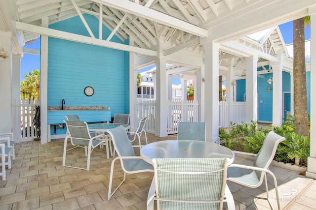 1219 Parasol Pl, Perdido Key, FL 32507 - sunroom / solarium featuring outdoor dining area, vaulted ceiling, and a skylight