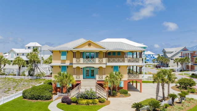 1219 Parasol Pl, Perdido Key, FL 32507 - coastal home with stairs, french doors, a balcony, driveway, and a porch