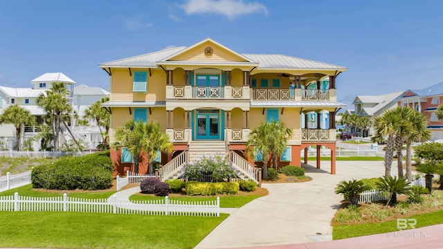 1219 Parasol Pl, Perdido Key, FL 32507 - coastal home featuring a balcony, covered porch, a carport, stairway, and french doors