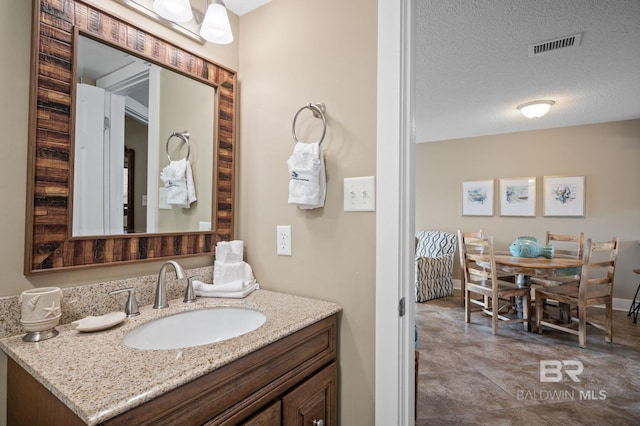 bathroom featuring vanity and a textured ceiling