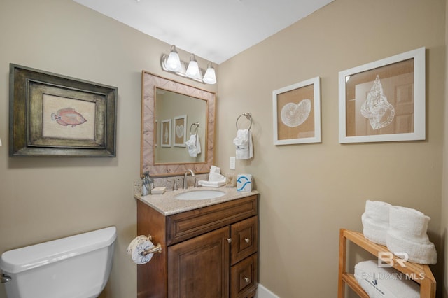 bathroom featuring vanity and toilet