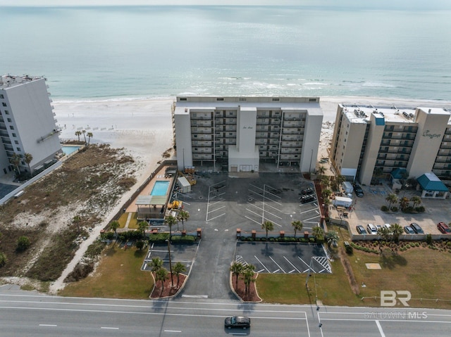 birds eye view of property with a view of the beach and a water view