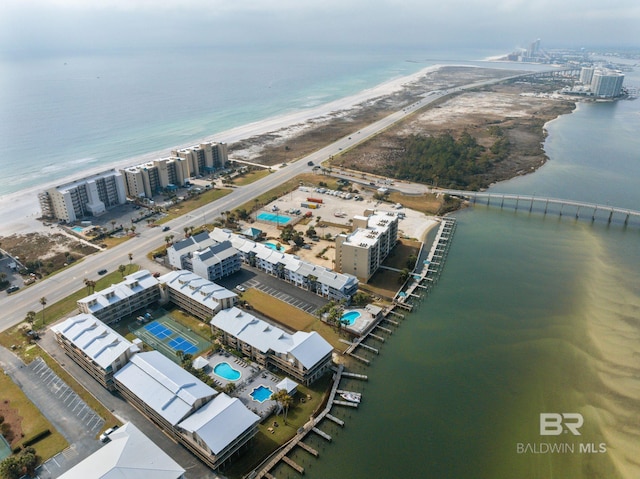 drone / aerial view featuring a water view and a view of the beach