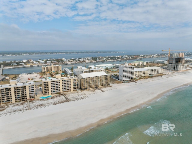 drone / aerial view featuring a water view and a view of the beach