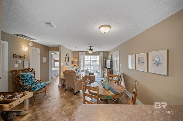 tiled dining area featuring a textured ceiling