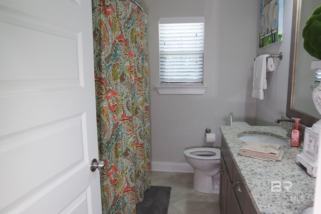 bathroom featuring vanity, toilet, and tile patterned floors