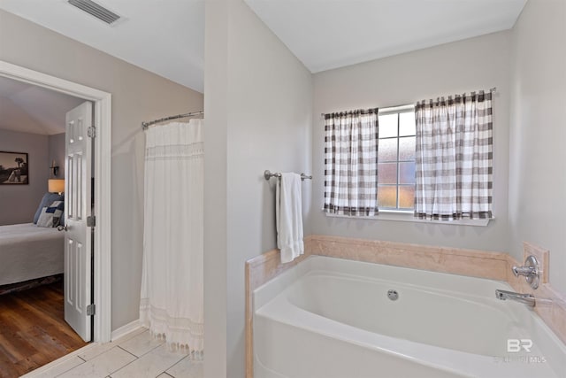 ensuite bathroom with a shower with curtain, visible vents, ensuite bathroom, and a garden tub