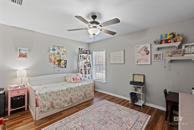 bedroom featuring ceiling fan, visible vents, baseboards, and wood finished floors