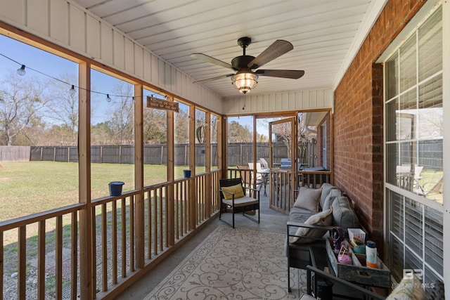 unfurnished sunroom featuring a ceiling fan