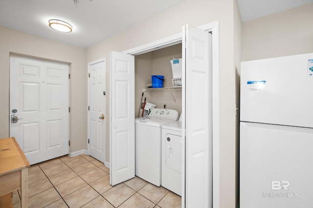 laundry area with laundry area, light tile patterned floors, and washer and dryer