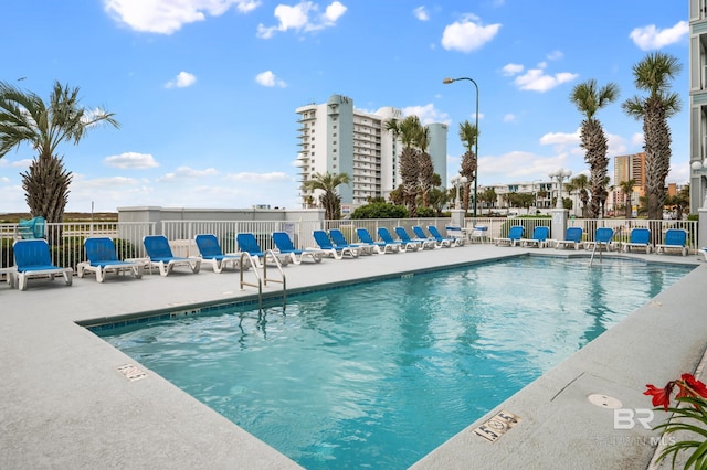 pool featuring a patio area and fence