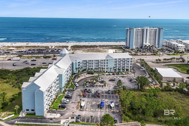 drone / aerial view featuring a water view and a beach view