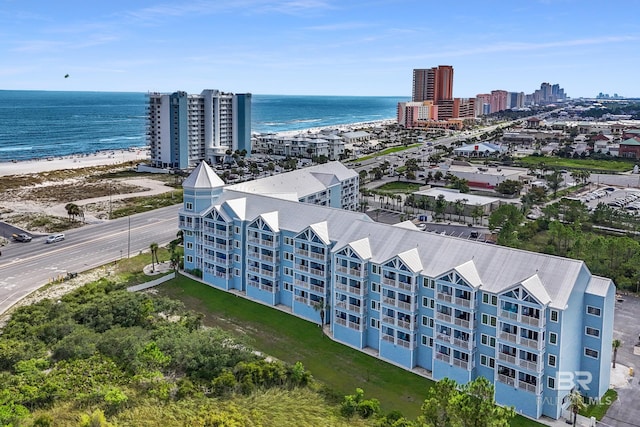 birds eye view of property with a view of the beach, a water view, and a view of city